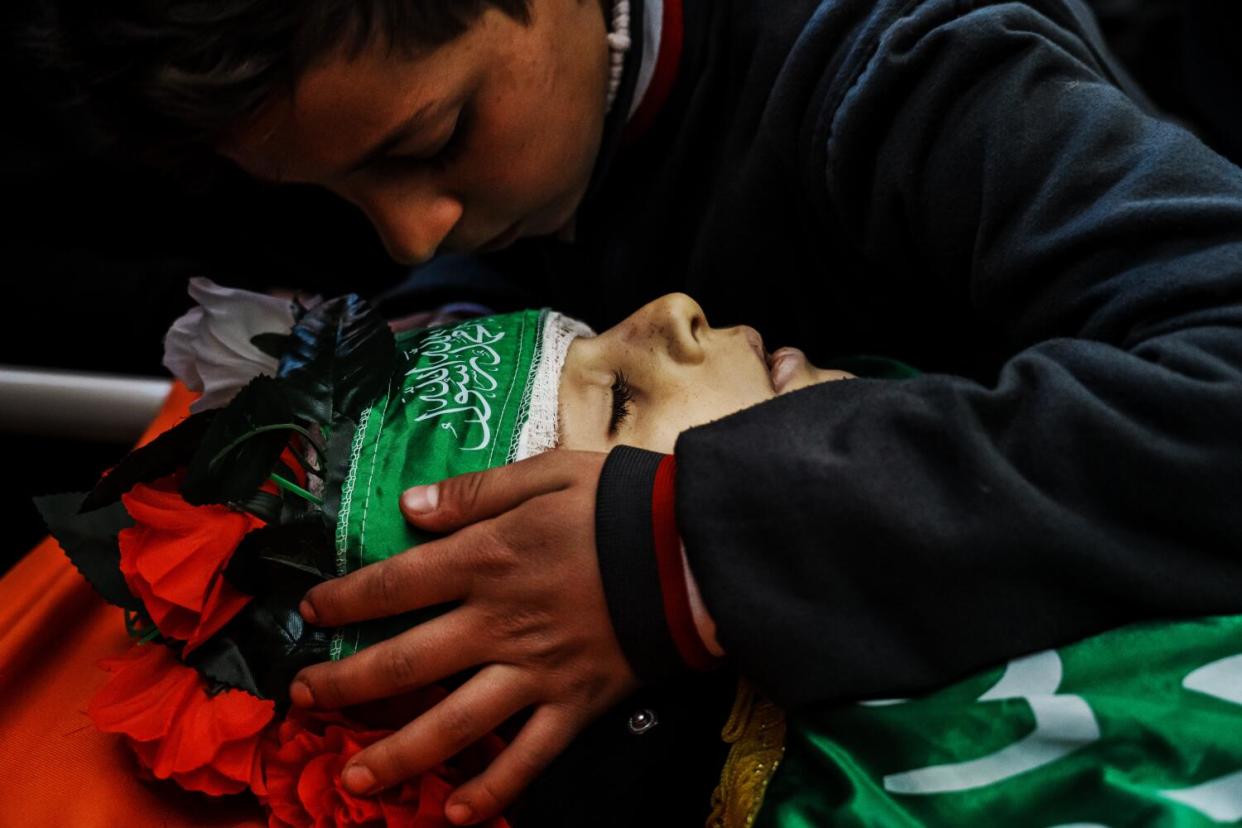 A young boy bids farewell to Amro Najjar, 10, who was killed by Israeli forces during an incursion the day before.