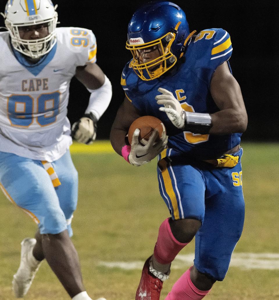 Sussex Central's Kevon Moore-Briddell (right) carries as Cape Henlopen's Tremaine Batson gives chase in Central's 35-16 win on Oct. 13.