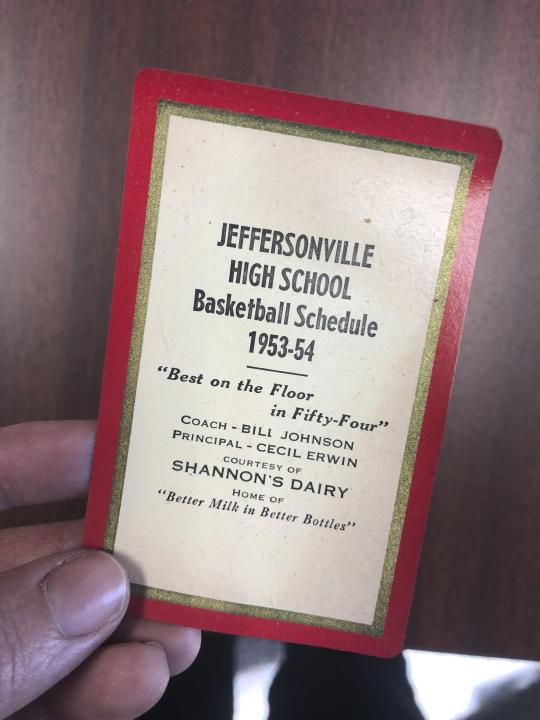 This undated photo provided by Greater Clark County Schools in Jeffersonville, Ind., shows a mid-1950s Jeffersonville High School basketball schedule found inside of a purse of a student who attended the school in the mid 1950s. The purse was recently discovered when a construction crew demolished part of the old Jeffersonville High School building. The purse, which contained a prom invitation, photos and other items from 1950s America, will be returned to its now 82-year-old owner after workers found it while demolishing part of an Indiana high school. (Greater Clark County Schools via AP)