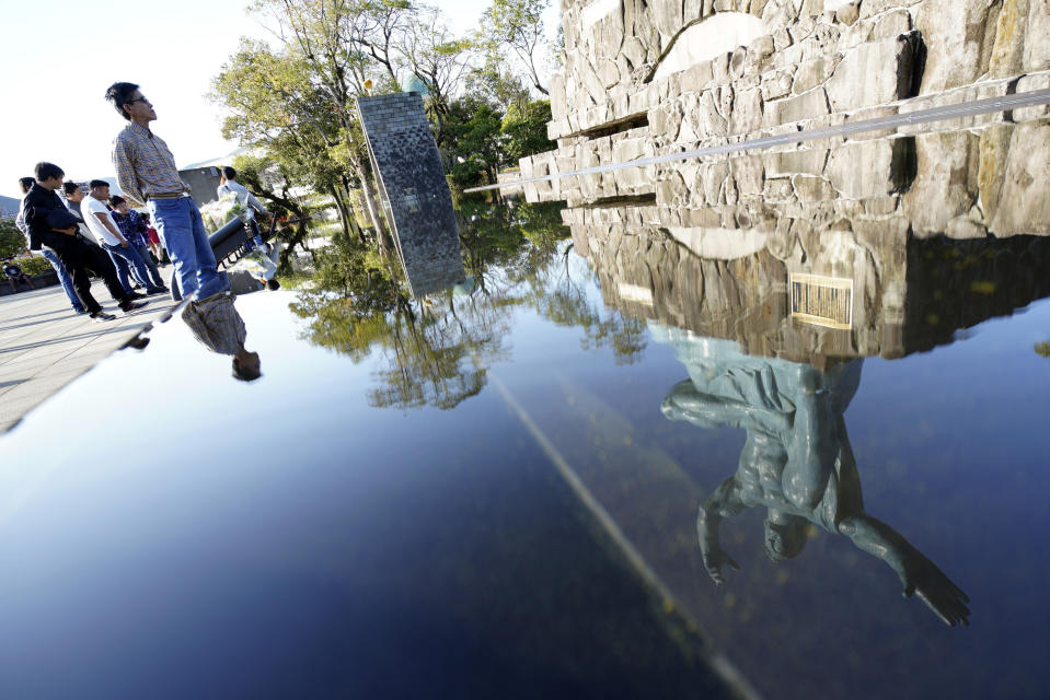 In this Nov. 16, 2019, photo, the Statue of Peace is reflected on water fountain at the Peace Park in Nagasaki, southern Japan. Pope Francis will start his first official visit to Japan in Nagasaki, ground zero for the Christian experience in a nation where the Catholic leader once dreamed of living as a missionary. (AP Photo/Eugene Hoshiko)