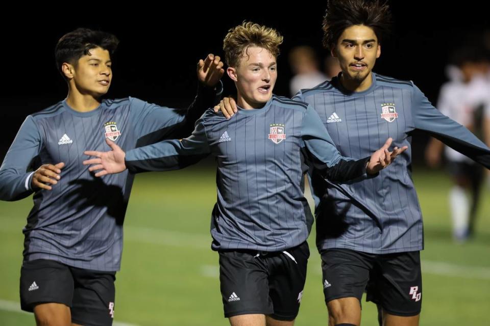 Paul Laurence Dunbar boys soccer players celebrate after scoring against Ryle during the state semifinals last season. Dunbar is the defending state champion.