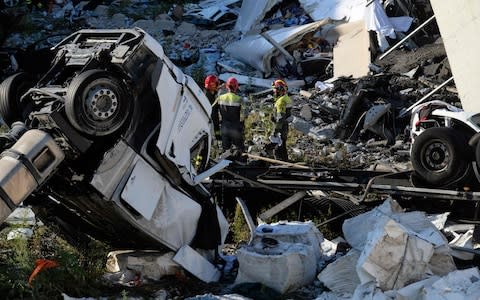 Rescuers inspect the rubble and wreckages by the Morandi motorway bridge - Credit:  ANDREA LEONI/AFP