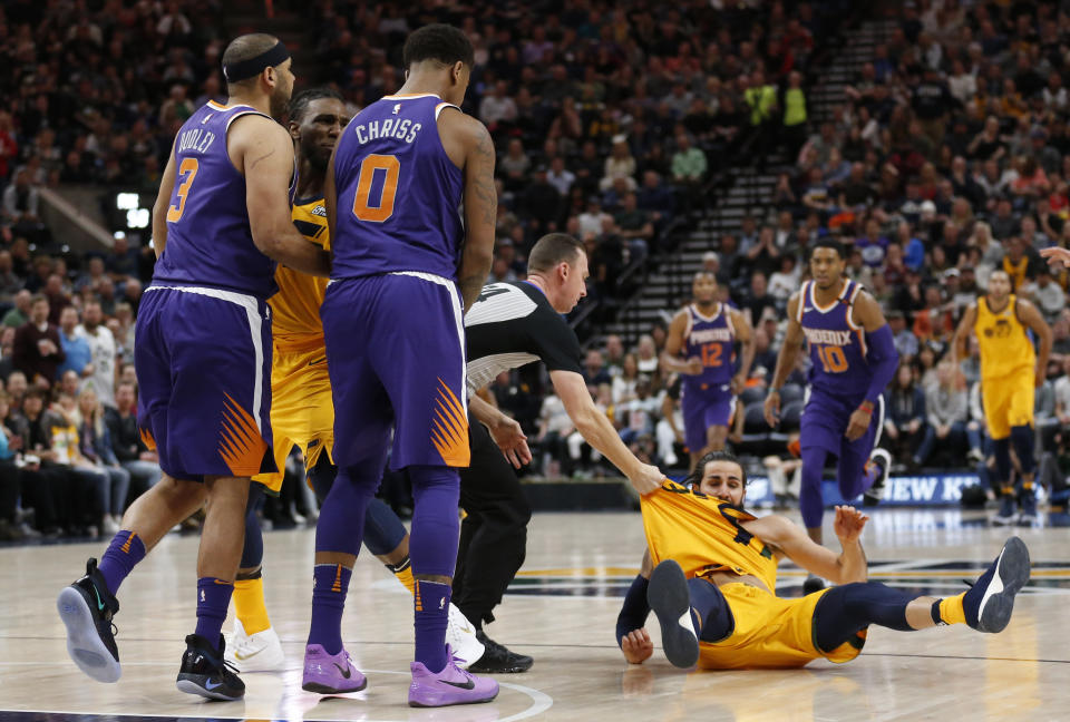 Phoenix Suns’ Jared Dudley (3) and Marquese Chriss (0) stand nearby after shoving Utah Jazz’s Ricky Rubio, right, to the court during the second of an NBA basketball game Thursday, March 15, 2018, in Salt Lake City. Dudley and Chriss were ejected with a flagrant 2 fouls. (AP Photo/Rick Bowmer)