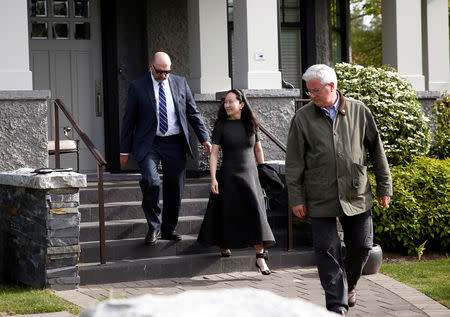 FILE PHOTO: Huawei's Financial Chief Meng Wanzhou leaves her family home flanked by private security in Vancouver, British Columbia, Canada, May 8, 2019. REUTERS/Lindsey Wasson/File Photo