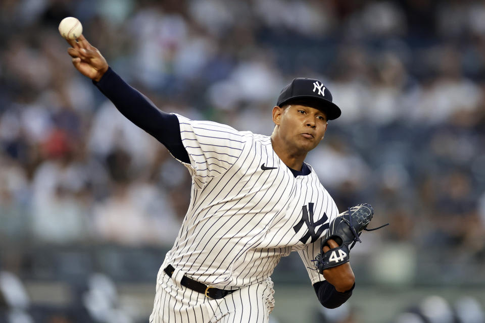 New York Yankees pitcher Jhony Brito throws to first base, keeping a Minnesota Twins baserunner close during the first inning of a baseball game Thursday, April 13, 2023, in New York. (AP Photo/Adam Hunger)