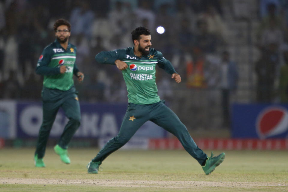 Pakistan's Shadab Khan, center, celebrates after taking the wicket of West Indies' Akeal Hosein during the third one day international cricket match between Pakistan and West Indies at the Multan Cricket Stadium, in Multan, Pakistan, Sunday, June 12, 2022. (AP Photo/Anjum Naveed)