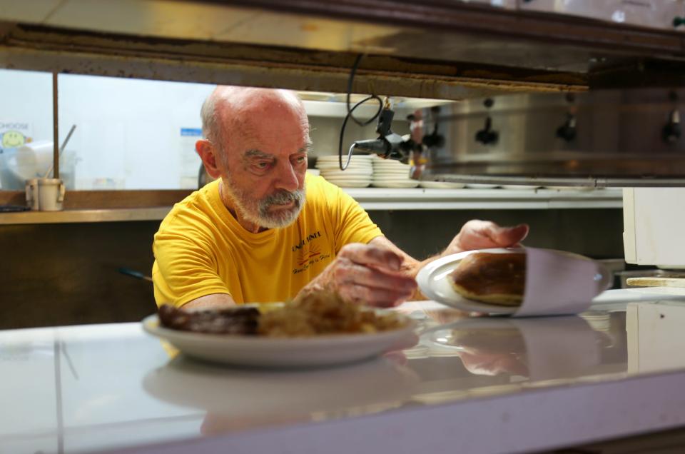 Don McClean serves a plate of food as he and his staff juggle a busy day at the Sunrise Diner on Aug. 29, 2022, in Lafayette.