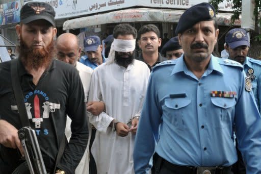 Pakistani policemen escort Islamic cleric Hafiz Mohammed Khalid Chishti upon his arrival at a court in Islamabad on September 2. The cleric who submitted evidence against a Christian girl accused of blasphemy has been arrested on suspicion of evidence-tampering and desecrating the Koran, police said