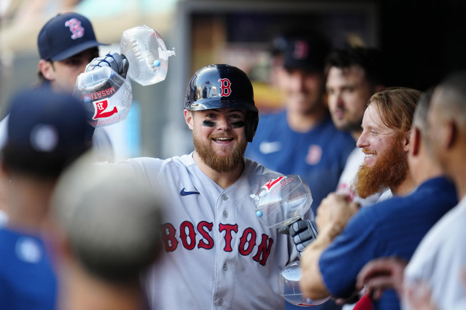 Boston Red Sox's Christian Arroyo, center, celebrates in the dugout after hitting a solo home run against the Minnesota Twins during the fourth inning of a baseball game Tuesday, June 20, 2023, in Minneapolis. (AP Photo/Abbie Parr)