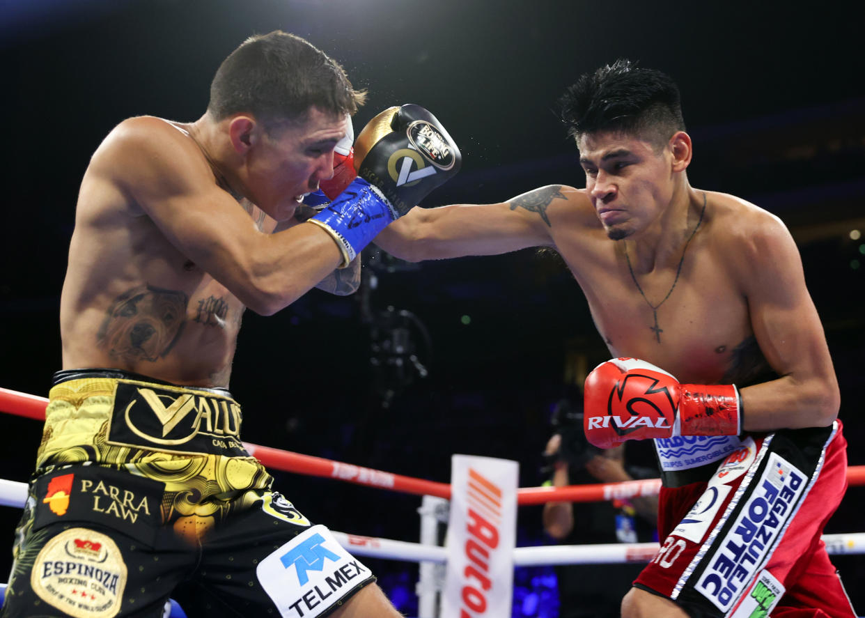 GLENDALE, ARIZONA - AUGUST 12: Oscar Valdez (L) and Emanuel Navarrete (R) exchange punches during their WBO junior lightweight championship fight at Desert Diamond Arena on August 12, 2023 in Glendale, Arizona. (Photo by Mikey Williams/Top Rank Inc via Getty Images)