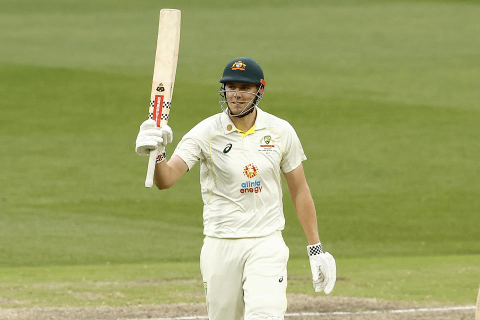 Seen here, Cameron Green raises his bat after scoring a half century against South Africa at the Melbourne Cricket Ground.