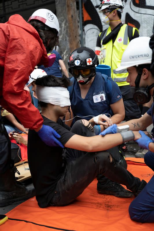 Chilean student Gustavo Gatica receive first aid care after being shot in the face by Chilean police with rubber bullets during a protests in Santiago