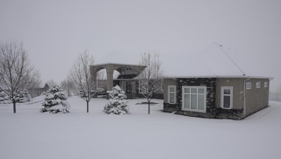 Armin Babic, 41, is accused of breaking into this home in the De Winton area south of Calgary in 2019 while wearing a police vest and then robbing a man at gunpoint.  (Court exhibit  - image credit)