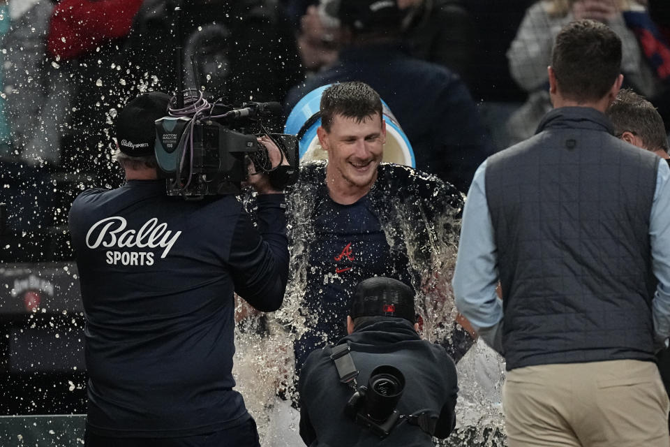 Atlanta Braves catcher Sean Murphy, center, is doused after hitting the winning two-run home run in the 10th inning of a baseball game against the Cincinnati Reds, Monday, April 10, 2023, in Atlanta. (AP Photo/John Bazemore)
