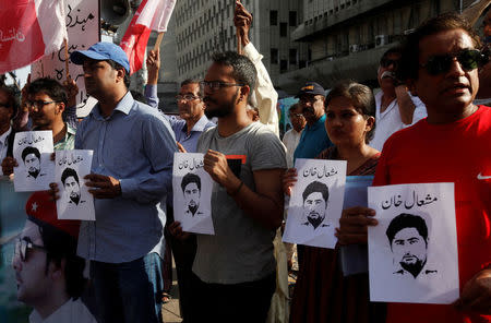 FILE PHOTO: Members of the Awami Workers Party hold pictures with the name of student Mashal Khan, who was beaten to death by fellow students after a dormitory debate was followed by accusations of blasphemy at Abdul Wali Khan University in Mardan, during a demonstration in Karachi, Pakistan April 18, 2017. REUTERS/Akhtar Soomro/File Photo