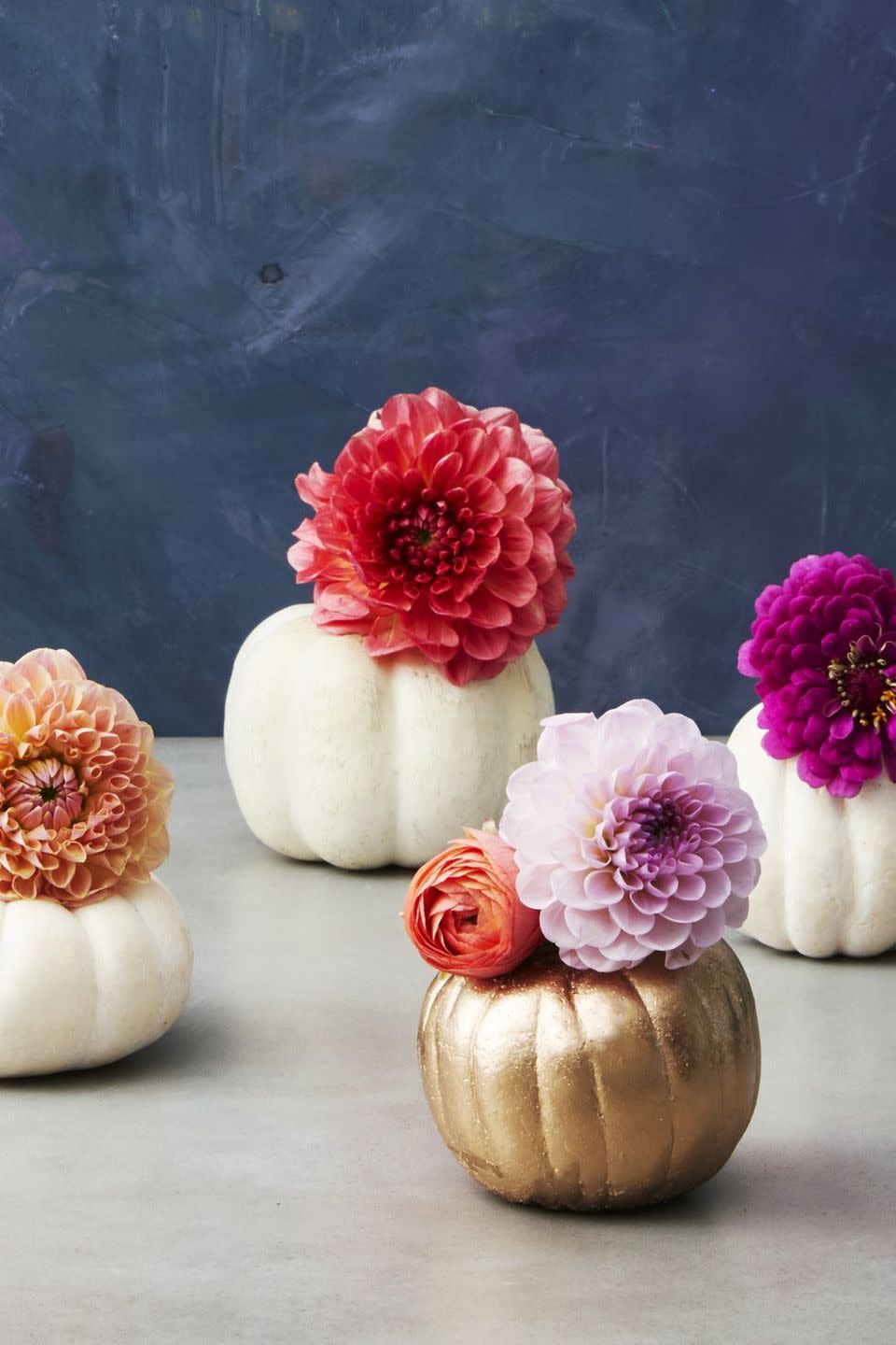 <p>If you have a long table, line it with a medley of mini pumpkins instead of going with a single statement. After carving the mini pumpkins like normal, cut off the bottom of water bottles and slide them right inside to act as vases.</p><p><strong>RELATED: </strong><a href="https://www.goodhousekeeping.com/holidays/halloween-ideas/g1714/no-carve-pumpkin-decorating/" rel="nofollow noopener" target="_blank" data-ylk="slk:The Best No-Carve Pumpkin Ideas;elm:context_link;itc:0;sec:content-canvas" class="link ">The Best No-Carve Pumpkin Ideas </a></p>