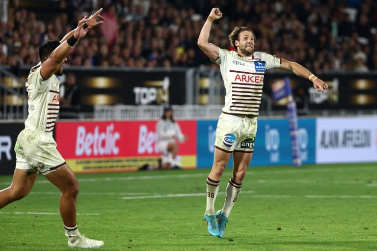 Jump for joy: Bordeaux scrum-half Yann Lesgourgues (R) celebrates victory (ROMAIN PERROCHEAU)