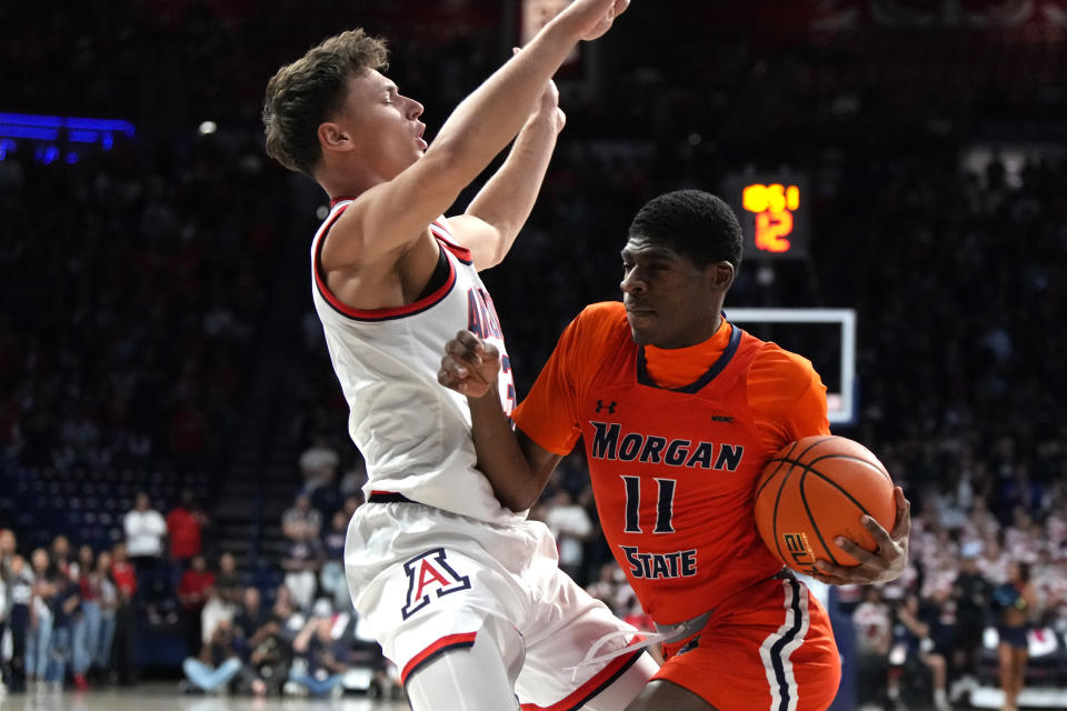 Morgan State guard Ahmarie Simpkins (11) drives against Arizona guard Pelle Larsson, left, during the first half of an NCAA college basketball game Monday, Nov 6, 2023, in Tucson, Ariz. (AP Photo/Rick Scuteri)