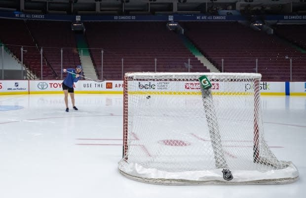 Vancouver Canucks goalie Thatcher Demko shoots a puck after the team's game against the Calgary Flames was postponed due to an outbreak of COVID-19 on March 31.