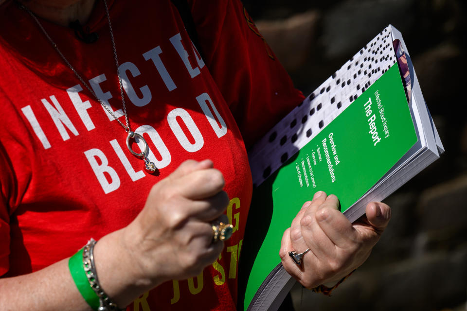 LONDON, ENGLAND - MAY 20: Jackie Britton, who was mistakenly infected with Hepatitis-C through a blood transfusion following the birth of her daughter in 1983, holds a copy of the final report outside the Methodist Central Hall following the release of findings of the six-year inquiry on May 20, 2024 in London, England. The findings of the official inquiry into the Infected Blood Scandal are published today by chair, Sir Brian Langstaff. Tens of thousands of people are estimated to have received contaminated blood through medical products in the 1970s and 1980s, resulting in the deaths of 3000. The government is also set to announce a £10bn compensation pot. (Photo by Leon Neal/Getty Images)