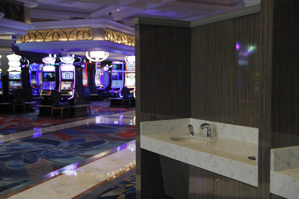 Hand washing stations have been installed in the casino area as a coronavirus safety measure at the closed Bellagio hotel and casino, Wednesday, May 20, 2020, in Las Vegas. Casino operators in Las Vegas are awaiting word when they will be able to reopen after a shutdown during the coronavirus outbreak. (AP Photo/John Locher)