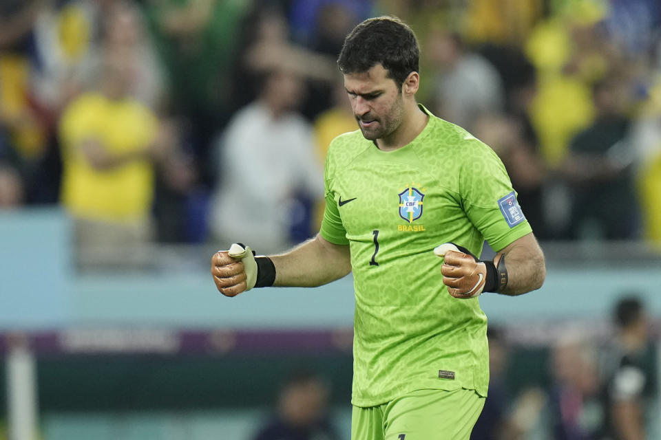 Brazil's goalkeeper Alisson celebrates after Casemiro scored the opening goal during the World Cup group G soccer match between Brazil and Switzerland at the Stadium 974 in Doha, Qatar, Monday, Nov. 28, 2022. (AP Photo/Hassan Ammar)