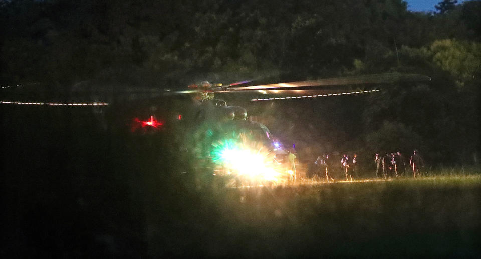 Thai medics and police officers evacuate the first two children with a helicopter after rescued from Tham Luang cave before heading to hospital. Source: AAP