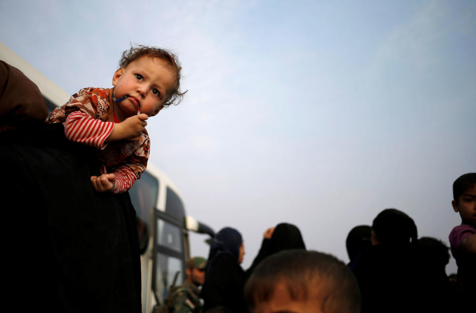 An internally displaced woman carries her child