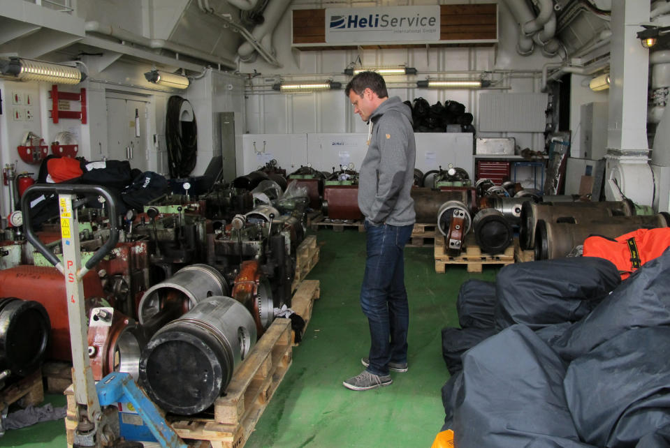 Markus Rex, an atmospheric scientist and leader of the MOSAiC expedition, examines equipment loaded onto the German Arctic research vessel Polarstern in Bremerhaven, Germany, on Wednesday, July 3, 2019. Scientists from 17 nations are preparing for a year-long mission to the central Arctic to study the impact that climate change is having on the frigid far north of the planet. Mission leader Markus Rex said that researchers plan to anchor the German icebreaker RV Polarstern to a large floe and set up camp on the ice as the sea freezes around them, conducting experiments throughout the Arctic winter. (AP Photos/Frank Jordans)