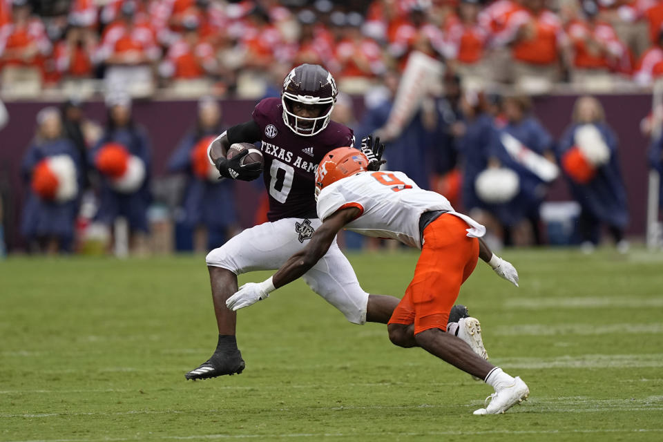 Texas A&M wide receiver Ainias Smith (0) tries to avoid being tackled by Sam Houston State defensive back Jordan Morris (9) during the second half of an NCAA college football game Saturday, Sept. 3, 2022, in College Station, Texas. (AP Photo/David J. Phillip)