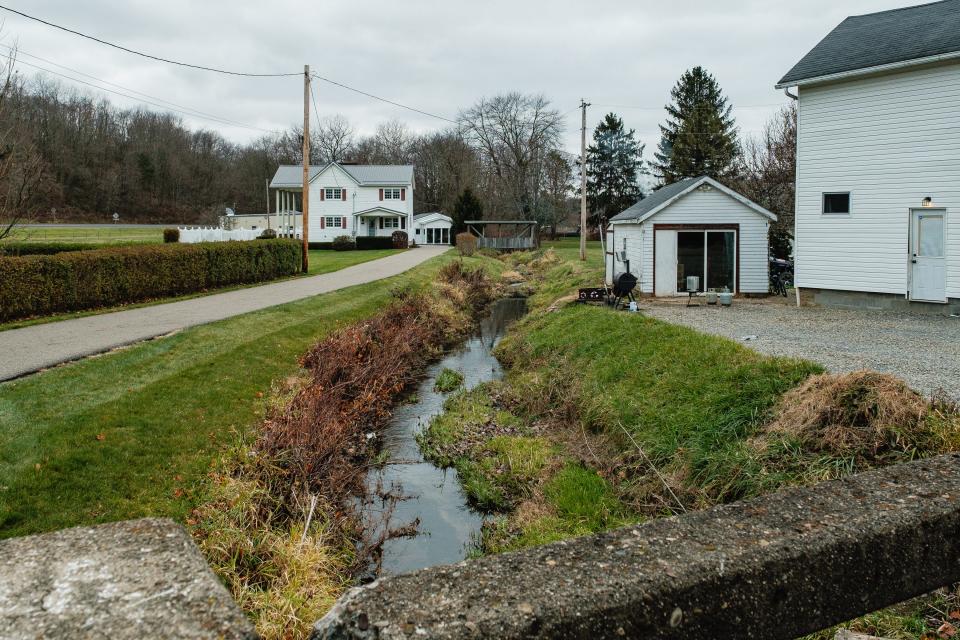 Beaverdam Creek can be seen flowing at the Barnhill Rd NE crossing in the Village of Roswell in Union Township in this T-R file photo. Commissioners recently voted to construct, own and operate a sewer system in the village.