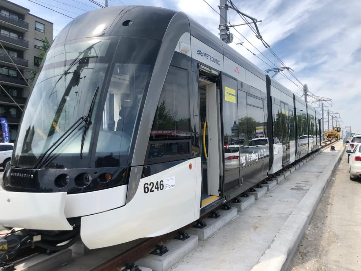 An Eglinton Crosstown test vehicle is loaded onto the tracks on Eglinton Avenue. Metrolinx says the public transit line won't be ready this fall as expected because the consortium building it has 'fallen behind schedule.' (Christopher Mulligan/CBC - image credit)