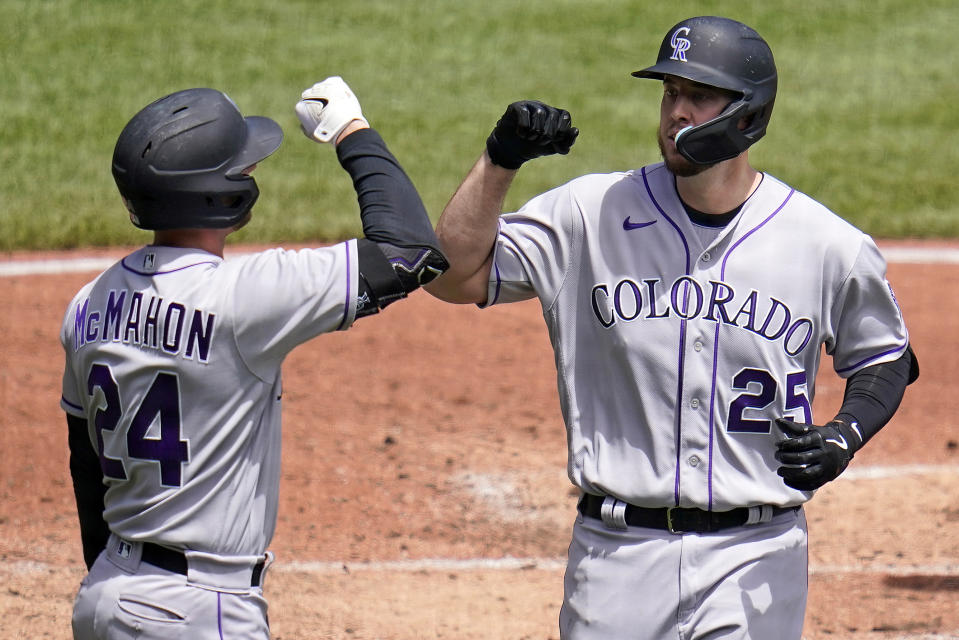 Colorado Rockies' C.J. Cron (25) is greeted by Ryan McMahon as he returns to the dugout after hitting a solo home run off Pittsburgh Pirates relief pitcher Zach Thompson during the third inning of a baseball game in Pittsburgh, Wednesday, May 25, 2022. (AP Photo/Gene J. Puskar)