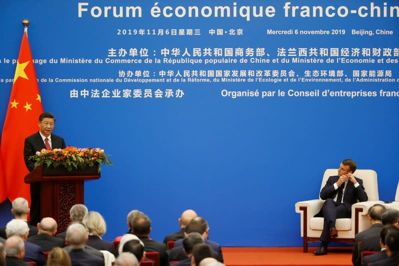 French President Emmanuel Macron and Chinese President Xi Jinping attend a China-France Economic Forum at the Great Hall of the People in Beijing
