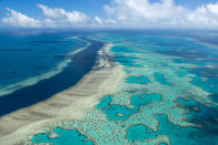 In this photo provided by the Great Barrier Reef Marine Park Authority the Hardy Reef is viewed from the air near the Whitsunday Islands, Australia, June 22, 2014. The Australian government on Friday, Jan. 28, 2022, pledged to spend another 1 billion Australian dollars ($704 million) over nine years on improving the health of the Great Barrier Reef after stalling a UNESCO decision on downgrading the natural wonder’s World Heritage status. (Jumbo Aerial Photography/Great Barrier Reef Marine Park Authority via AP)