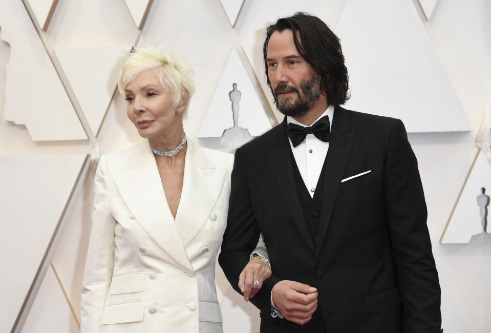 Patricia Taylor, left, and Keanu Reeves arrive at the Oscars on Sunday, Feb. 9, 2020, at the Dolby Theatre in Los Angeles. (Photo by Richard Shotwell/Invision/AP)