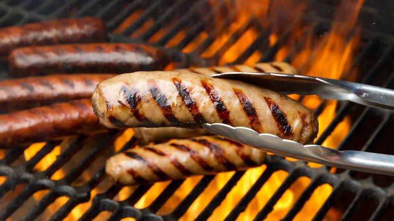 Bratwurst on flaming grill