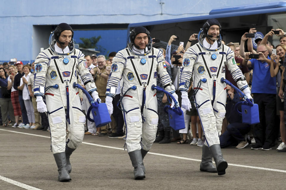 From left: U.S. astronaut Andrew Morgan, Russian cosmonaut Alexander Skvortsov and Italian astronaut Luca Parmitano, members of the main crew of the expedition to the International Space Station (ISS), walk prior the launch of Soyuz MS-13 space ship at the Russian leased Baikonur cosmodrome, Kazakhstan, Saturday, July 20, 2019. (AP Photo/Yuri Kochetkov, Pool)