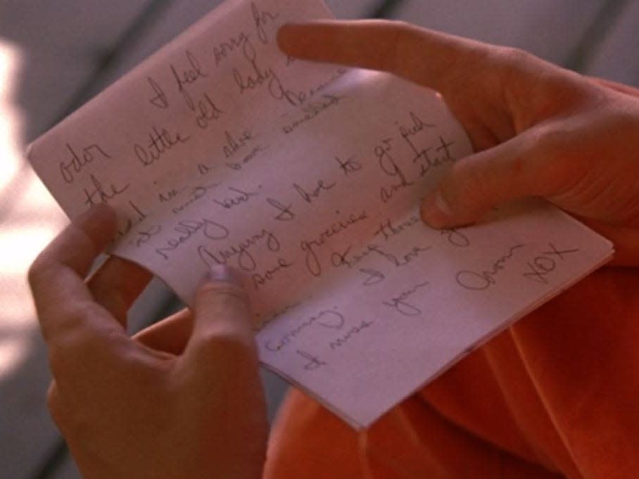 stanley holding a letter in a scene in holes