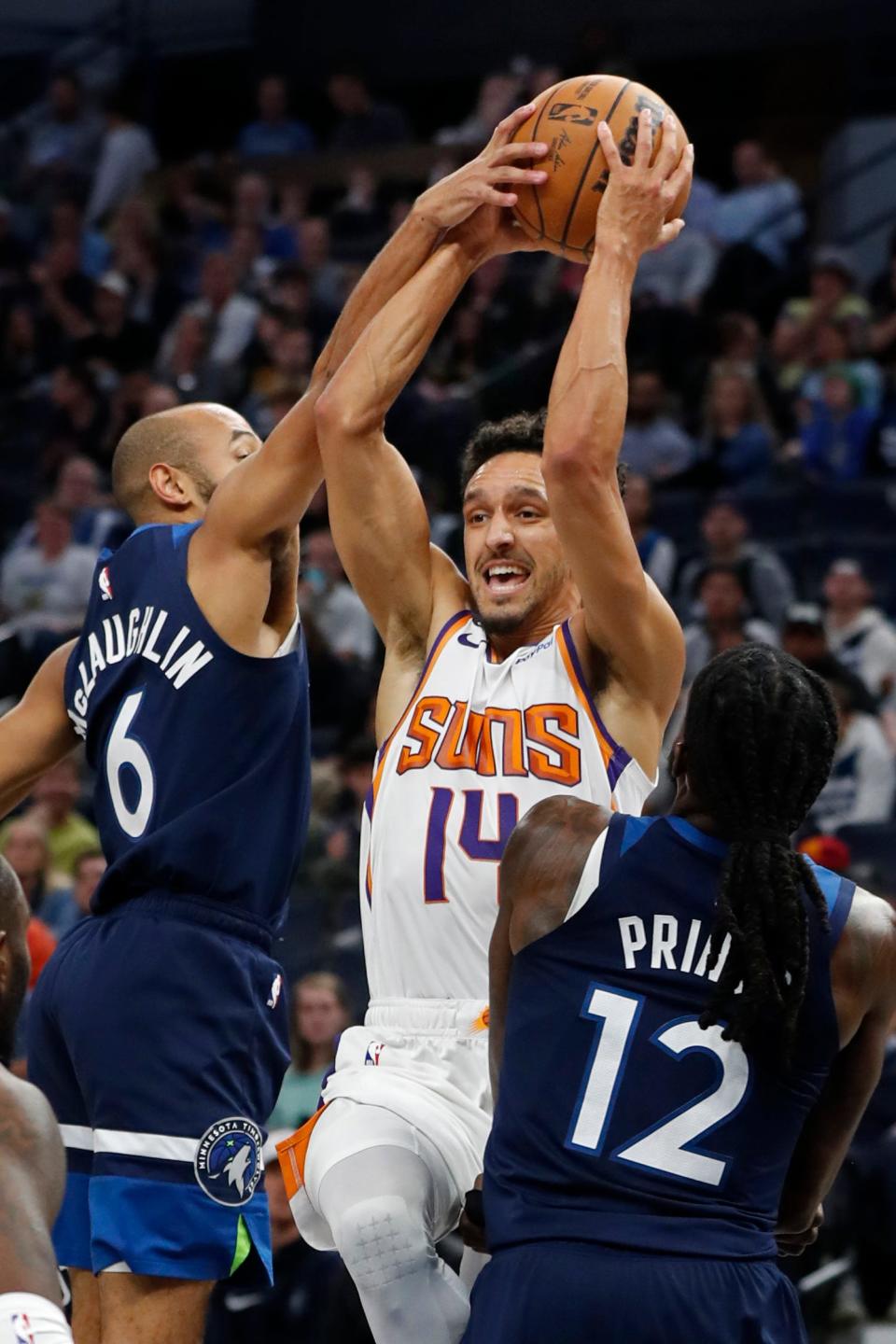 Phoenix Suns guard Landry Shamet (14) goes to the basket as Minnesota Timberwolves guard Jordan McLaughlin (6) fouls him and forward Taurean Prince (12) defends during the first quarter of an NBA basketball game Wednesday, Nov. 9, 2022, in Minneapolis. (AP Photo/Bruce Kluckhohn)