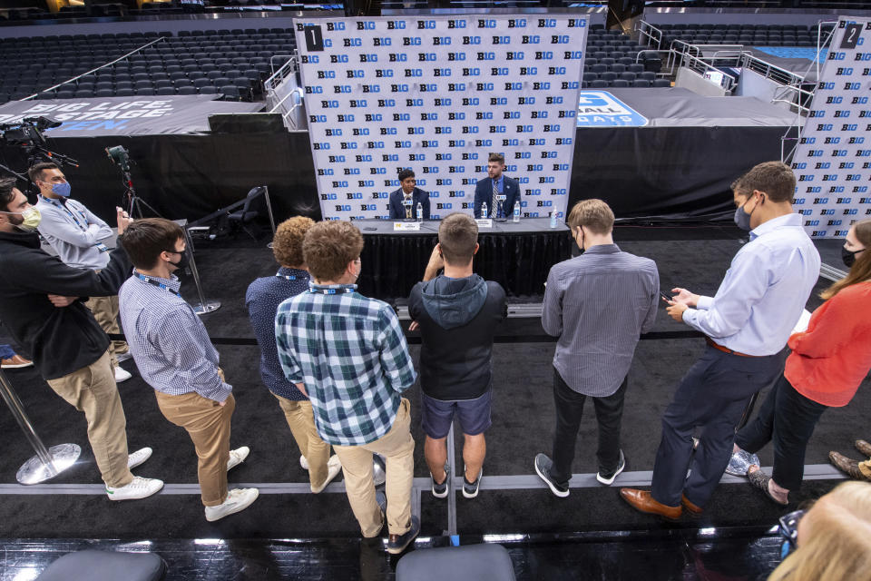 Michigan's Eli Brooks, left, and teammate Hunter Dickinson address the media during the first day of the Big Ten NCAA college basketball media days, Thursday, Oct. 7, 2021, in Indianapolis. (AP Photo/Doug McSchooler)