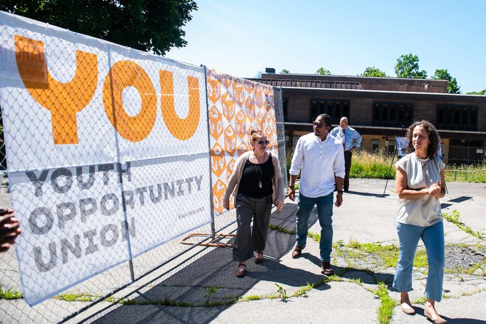 YOU advisory committee members unveil the fence panel artwork during a press conference for the start of demolition of the YMCA building in the city of Poughkeepsie, NY on Monday, June 6, 2022.