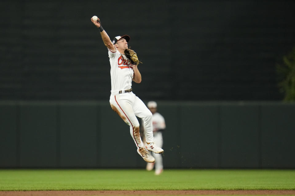 Baltimore Orioles second baseman Adam Frazier attempts to throw out St. Louis Cardinals' Nolan Arenado on a single in the fifth inning of a baseball game, Monday, Sept. 11, 2023 in Baltimore. (AP Photo/Julio Cortez)