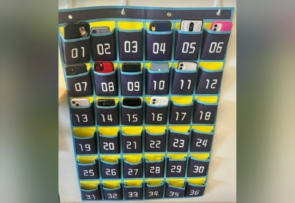 At Nixa High School, students will be required to store their cellphones in a central location at the start of each class. Teachers can use locking pouches or a numbered pocket organizer like this one, which can also used for calculators.