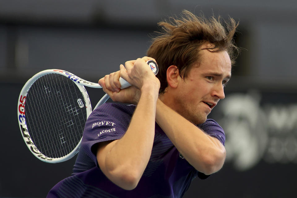 FILE - Russia's Daniil Medvedev makes a backhand return to Serbia's Miomir Kecmanovic during their Round of 16 match at the Adelaide International Tennis tournament in Adelaide, Australia, Wednesday, Jan. 4, 2023. The 2023 Grand Slam season begins at the Australian Open next week. (AP Photo/Kelly Barnes, File)