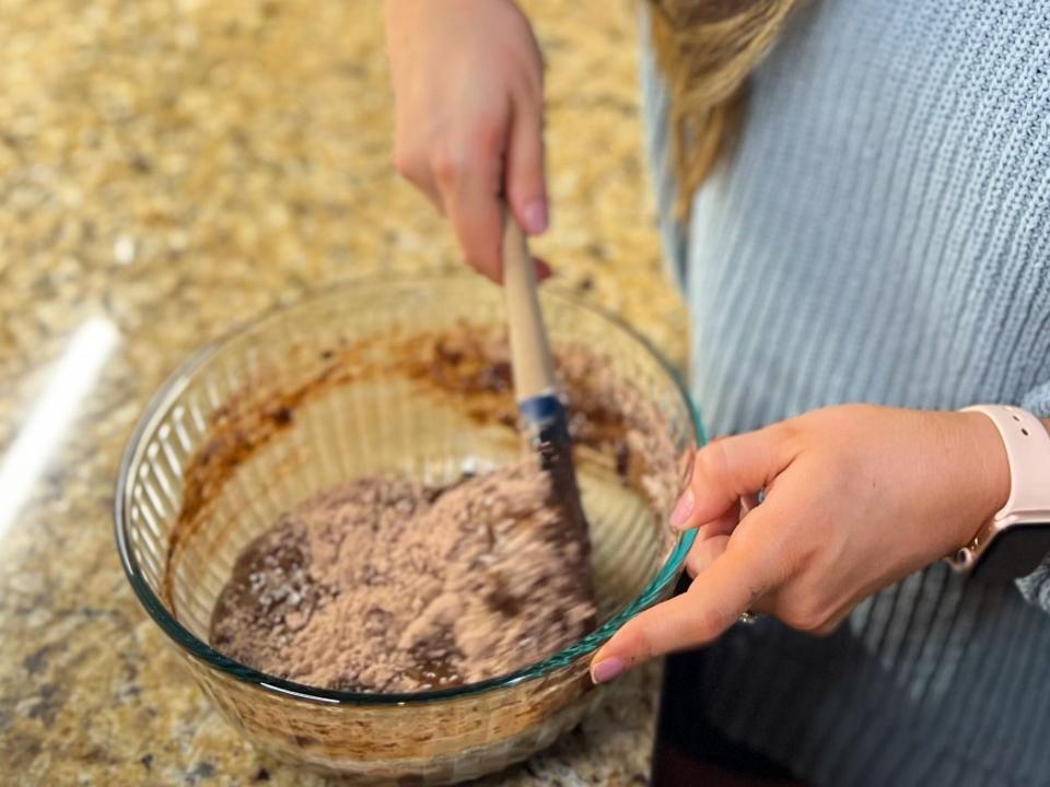 maddie stiring together brownie mix