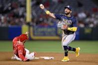 Tampa Bay Rays shortstop Jose Caballero, right, throws to first after forcing out Los Angeles Angels' Taylor Ward (3) on a double play hit into Brandon Drury during the eighth inning of a baseball game in Anaheim, Calif., Tuesday, April 9, 2024. (AP Photo/Alex Gallardo)