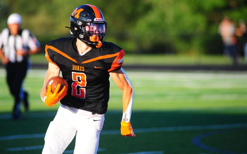 Marlington's Beau Himmelheber carries the ball in the open field against Warrensville Heights, Friday, Aug. 18, 2023.