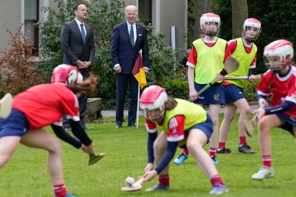President Joe Biden and Ireland's Taoiseach Leo Varadkar watch as girls play hurling during a youth Gaelic sports demonstration at Farmleigh House, (AP)