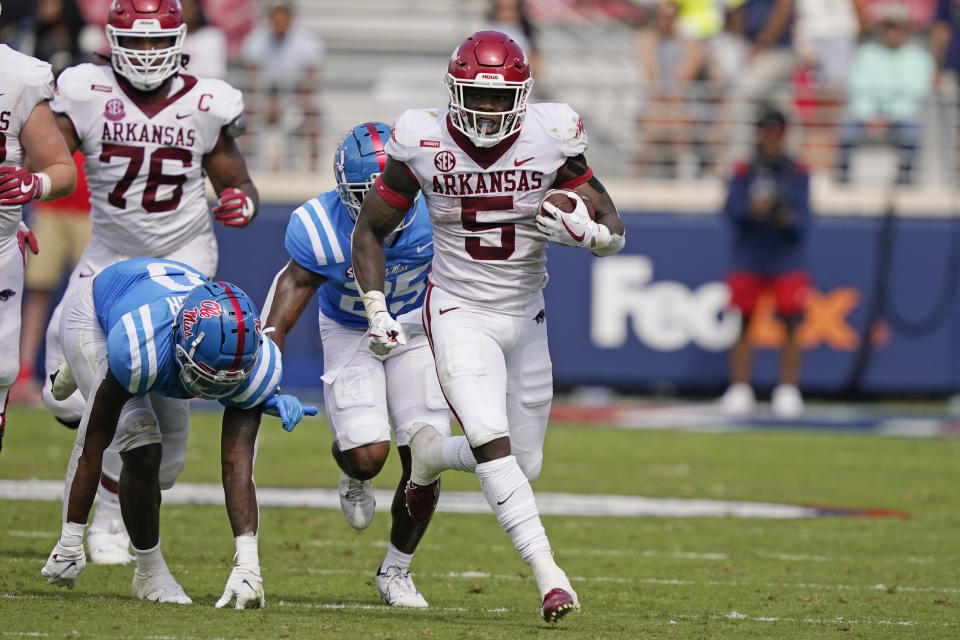 Arkansas running back Raheim Sanders (5) runs past Mississippi defenders for a first down during the second half of an NCAA college football game, Saturday, Oct. 9, 2021, in Oxford, Miss. Mississippi won 52-51.(AP Photo/Rogelio V. Solis)